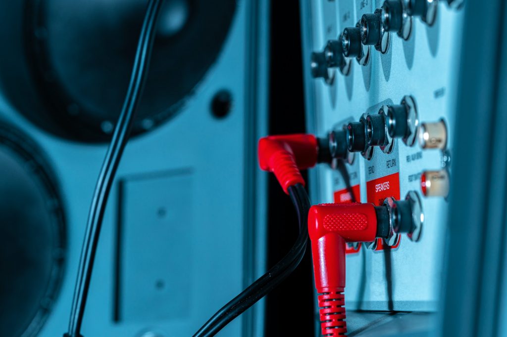 Rear panel of music system amplifier with wires